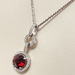  Adjustable Necklace And A 14Kt White Gold Pendant With a Garnet Stone